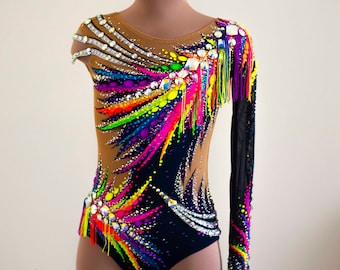 May include: A black and brown leotard with a rainbow design and rhinestones. The leotard has a long sleeve on one arm and a short sleeve on the other. The leotard has a fringe detail on the shoulder. The leotard is on a mannequin. @leo_leotard by Nataly  Brazhevksa