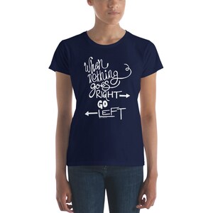 May include: A navy blue t-shirt with white text that reads "When nothing goes right, go left" with arrows pointing in the directions of the text.