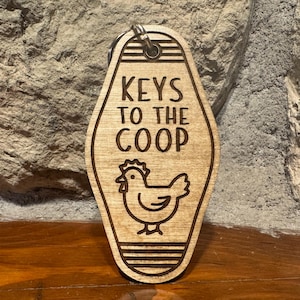 May include: Wooden keychain shaped like a motel key with the text "KEYS TO THE COOP" and a chicken illustration.
