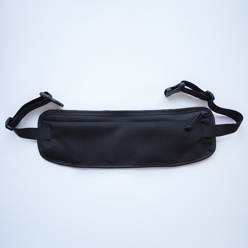 May include: Black travel money belt with a zippered pocket and adjustable straps.