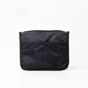 May include: Black zippered pouch with a mesh pocket and a small loop on the front.