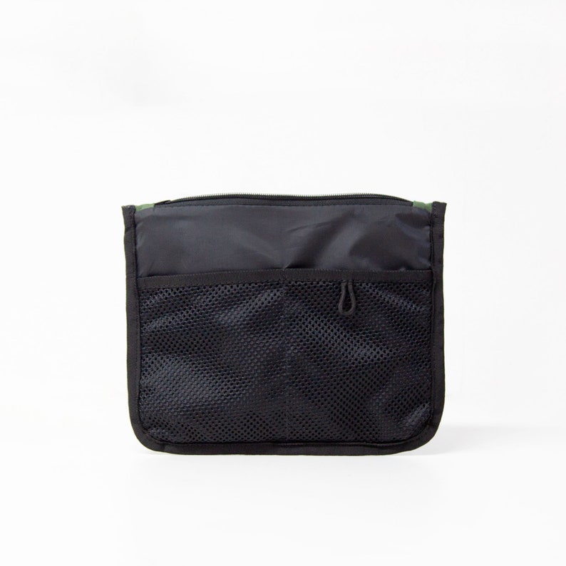 May include: Black zippered pouch with a mesh pocket and a small loop on the front.