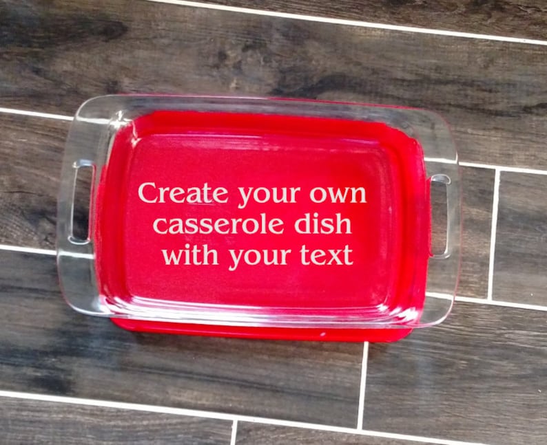 May include: A red glass casserole dish with clear handles. The dish has the text "Create your own casserole dish with your text" printed on it.