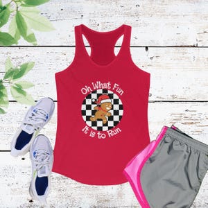 May include: Red tank top with a white circle graphic featuring a gingerbread man running on a checkered background. The text "Oh What Fun It is to Run" is printed around the circle.