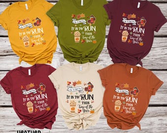 May include: Six different color t-shirts with a Thanksgiving-themed design. The design features a turkey, coffee cup, and leaves with the text "It is to run this time of the year". The colors of the shirts are mustard, olive, maroon, heather cardinal, tan, and autumn.
