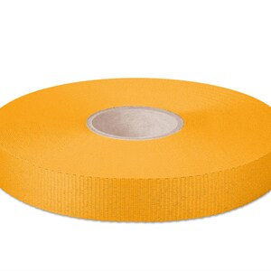 May include: A roll of bright yellow ribbon, 20 mm wide.