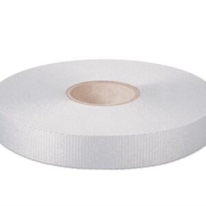 May include: A roll of white, 20 mm wide, woven ribbon.