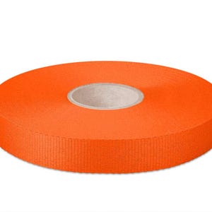 May include: A roll of bright orange ribbon, 20 mm wide.