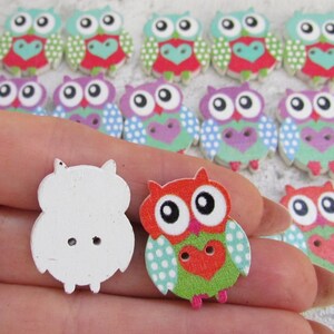 May include: Assortment of wooden owl buttons with various colorful patterns. Some buttons are plain white. The buttons are approximately 2 inches in diameter.
