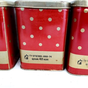May include: Three red metal canisters with white polka dots and gold trim. Each canister has a label with the text "TY 573/205-088-74 ЦЕНА 40 КОП".
