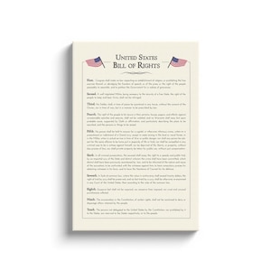 May include: A canvas print of the United States Bill of Rights. The text is printed in black on an off-white background, with two American flags at the top. The print is rectangular and mounted on a white frame.