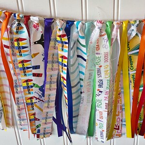 May include: A colorful fabric banner with various patterns and text, including "Create Paste", "Brush Scribble Paste", "Paper Draw Splatter Canvas Doodle", and "Crayola".