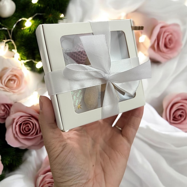 Shows a pretty white gift box with matching ribbon.
