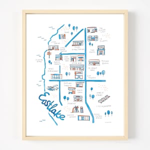 May include: A hand-drawn map of Eastlake, a neighborhood in Seattle, Washington. The map features various shops, restaurants, and landmarks, including the Flower Lady, Le Fournil, Sushi Kappo Tamura, Tops School, Lake Union Mail, Hamlin Market, Other Bar, 14 Carrot Cafe, Zoo Tavern, Eastlake Coffee Co, Morti Cabin, Home et Stairs, 1-5 Colonnade, Grand Central Bakery, and Yokoso Noodles.