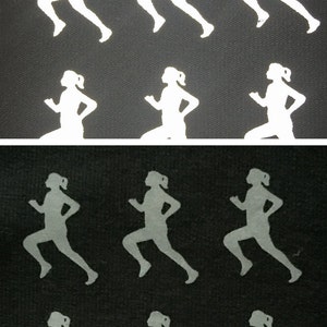 May include: A black fabric with white reflective running figures printed on it. The figures are in a running pose, with arms bent and legs extended.