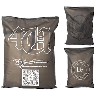 May include: Three dark gray zippered bags. The largest bag has the text "47H" in a bold, white font, with "Forty Seven Uncommon" below it. A QR code is also visible. The other two bags have graphic designs and text.