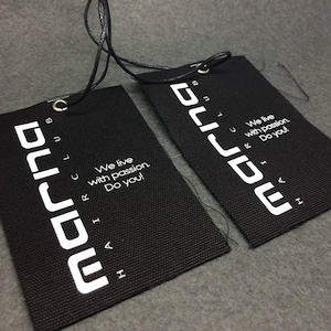 May include: Two black fabric tags with white text that reads "marina club" and "We live with passion. Do you!"