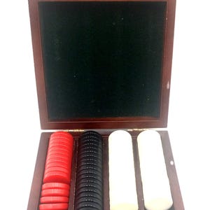 May include: A wooden backgammon set with a dark brown finish. The open box reveals a green felt interior and compartments holding red, black, and white game pieces. The set is designed for strategic board game play.