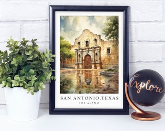 May include: A framed watercolor painting of The Alamo in San Antonio, Texas. The building is a light brown color with a dark brown door and windows. The painting is set against a white brick wall with a small green plant in a white pot to the left and a black globe with the word "explore" written on it to the right.