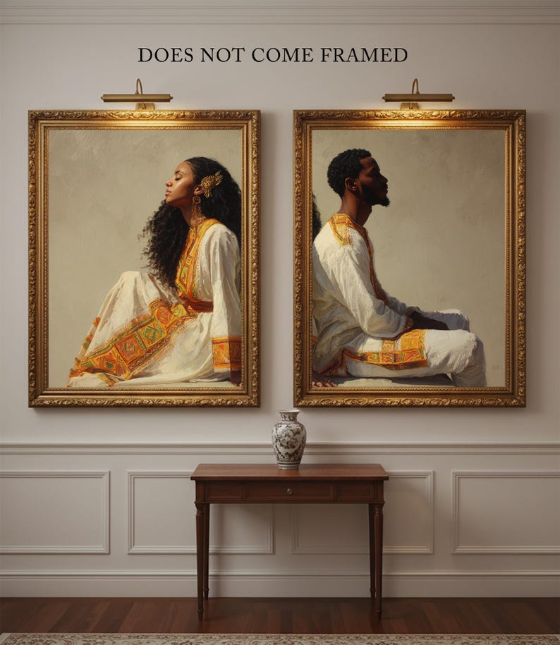 May include: Two framed portraits of people in traditional attire, with gold frames and warm lighting. The text "DOES NOT COME FRAMED" is above the portraits. A small wooden table and a decorative vase are below the portraits.