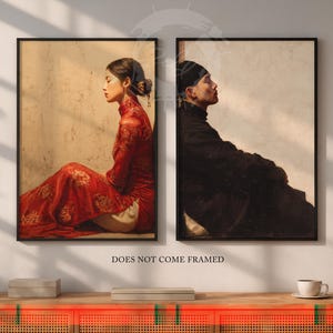 May include: Two framed art prints. One features a person in a red dress, the other a person in black clothing. Both are in profile, set against a neutral background. The text "DOES NOT COME FRAMED" is at the bottom.