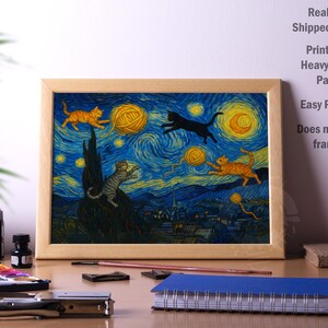 May include: Framed print featuring a whimsical adaptation of Van Gogh's "Starry Night," with cats playing with yarn balls under a swirling blue and yellow sky. The artwork is printed on heavyweight paper.
