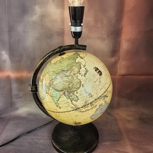 Large vintage spinning world globe table lamp light.