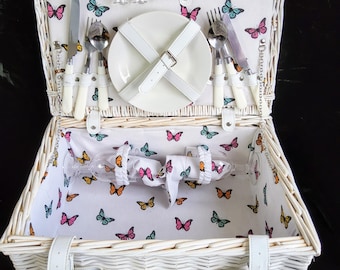 Romantic vintage outdoor white wicker picnic basket set with butterfly interior fabric.  Complete picnic set for 2 people.