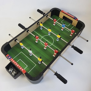 Small table football game, table top football. 19 inches long by 11 inches wide.