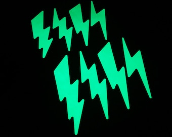 May include: A set of eight glow-in-the-dark lightning bolt stickers. The stickers are a bright green color and are perfect for adding a fun and unique touch to any project.