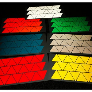 May include: Eight sheets of reflective triangle stickers in various colors, including white, orange, green, blue, beige, red, yellow, and gold.