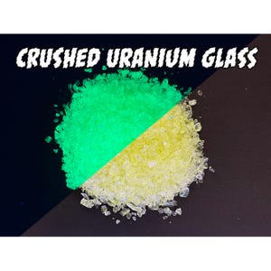 May include: A split image of crushed uranium glass. The top half glows bright green, while the bottom half is a pale yellow. The text "CRUSHED URANIUM GLASS" is at the top in white, stylized lettering.