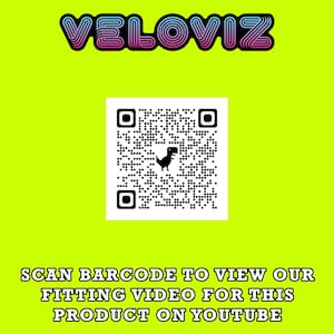 May include: A yellow background with a pink and blue text overlay that says "VELOVIZ". Below the text is a black and white QR code with a small black dinosaur icon in the center. Below the QR code is the text "SCAN BARCODE TO VIEW OUR FITTING VIDEO FOR THIS PRODUCT ON YOUTUBE."