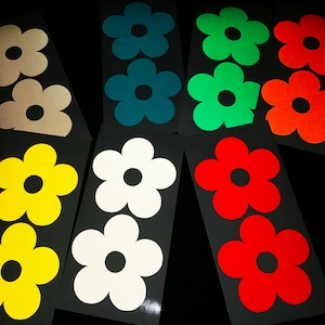 Peut inclure: Dix feuilles d'autocollants de fleurs colorées dans différentes couleurs, y compris le rouge, l'orange, le jaune, le vert, le bleu et le blanc. Chaque feuille contient deux grands autocollants de fleurs.