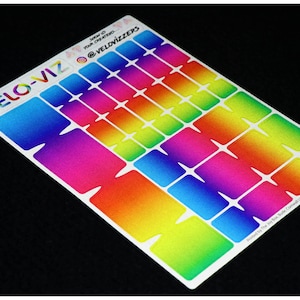 May include: A sheet of rainbow gradient stickers with a white border. The stickers are arranged in rows and columns, and each sticker has a different color gradient. The sheet is labeled "VELO-VIZ" and "Show off your creations @VELOVIZZZERS".