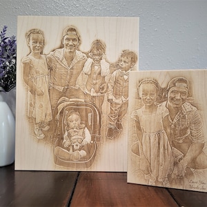 May include: Two wood plaques with laser engraved images of a family. The larger plaque shows a man with five children, including a baby in a car seat. The smaller plaque shows the man with one of the children. The smaller plaque has the text "Love You Uncle Joe" at the bottom.