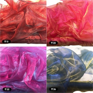 May include: Four swatches of iridescent sheer fabric in red, pink, blue, and black. The fabric is translucent and has a shimmery finish. The swatches are labelled with the numbers TT 13, TT 20, TT 22, and TT 26.