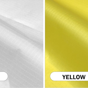 May include: Close-up of two fabric samples, one white and one yellow. The white fabric is on the left, and the yellow fabric is on the right. The word "WHITE" is in a white oval on the bottom left, and "YELLOW" is in a yellow oval on the bottom right.