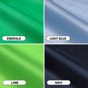 May include: Close-up of four fabric swatches in different colors: emerald green, light blue, lime green, and navy blue. Each swatch has a grid-like texture and a label with the color name.