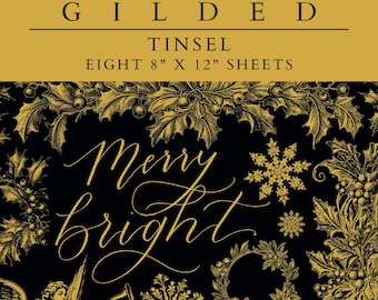 May include: A set of eight 8x12 inch sheets of gold foil paper with a Christmas theme. The paper features a black background with gold lettering that says "Merry & Bright" and a gold illustration of a snowflake, holly, and a wreath. The paper also features a gold illustration of an angel playing a trumpet and a sheet of music with the words "The First Nowell".