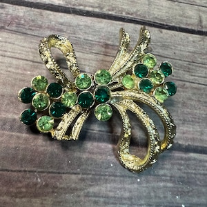 Vintage Bow Costume Jewelry from the 1960&#39;s Emerald Green and Light Green on a Gold Bow MCM Style Rhinestone Brooch Marked Corocraft