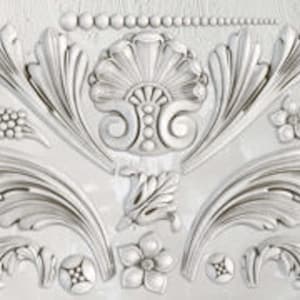 May include: A set of 12 decorative, white, plaster moldings featuring intricate, floral designs. The moldings are perfect for adding a touch of elegance to any project.