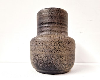 May include: A dark brown ceramic vase with a speckled glaze. The vase has a rounded body and a slightly flared opening.
