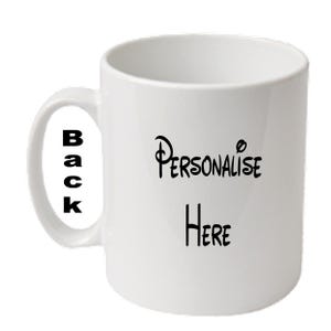 May include: White ceramic mug with a curved handle. The mug features the words "Personalise Here" in black script on the front and "Back" in black block letters on the handle. A simple, everyday coffee mug.
