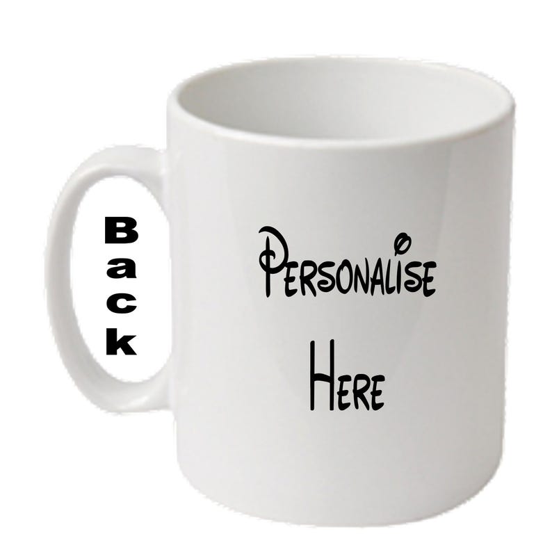 May include: White ceramic mug with a curved handle. The mug features the words "Personalise Here" in black script on the front and "Back" in black block letters on the handle. A simple, everyday coffee mug.