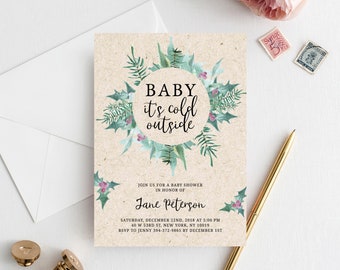 May include: A baby shower invitation with a watercolor wreath of green leaves and red berries. The text reads "BABY it's cold outside" and includes the date, time, and location of the event.