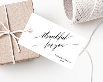 May include: White gift tag with black calligraphy that reads "thankful for you" and the text "Thanksgiving 2018".