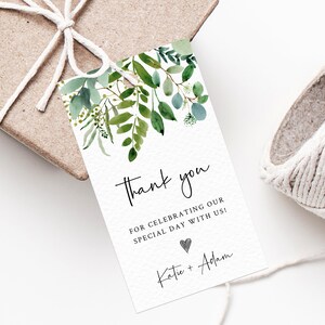 May include: A white thank you tag with green watercolour leaves and the text "Thank you for celebrating our special day with us! Katie + Adam".