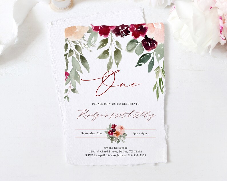 May include: A watercolor-style invitation with floral accents. The design features burgundy and peach flowers with green foliage. The word "One" is written in a cursive font, and the text "Roselyn's first birthday" is also included.