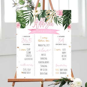 May include: A pink and green printable birthday sign for a 2-year-old girl named Addison. The sign includes details about her weight, height, and things she loves to do. It features a tropical theme with palm leaves and flowers.